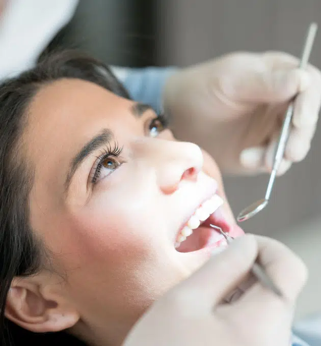 Patient receiving dental filling treatment at The Village Dentistry, a Houston dental office.