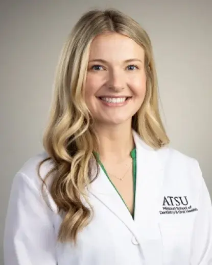 Dr. Lindborg, dentist at ATSU dental practice in Houston, smiling professionally in white coat.